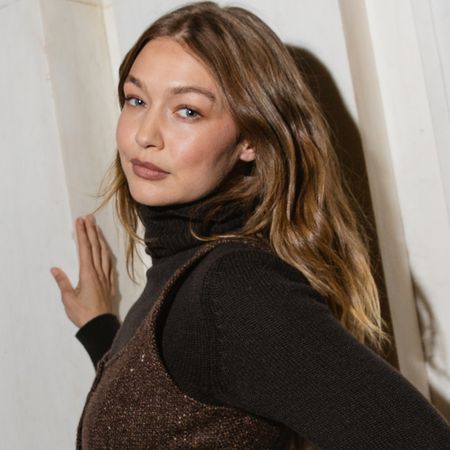 Gigi Hadid wore jeans, cowboy boots, a tank top, and Western hat inspired by her sister, Bella Hadid.