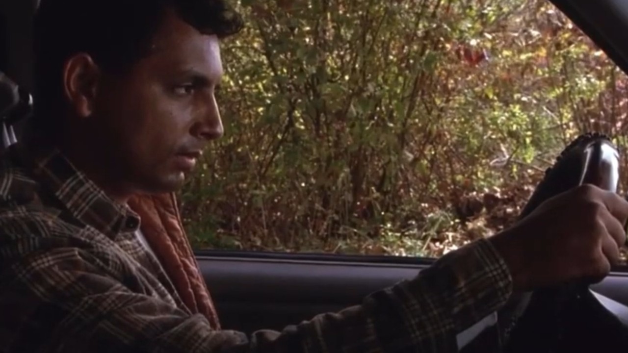 M. Night Shyamalan sadly sitting in a car in Signs