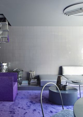 A living room drenched in purple and gray