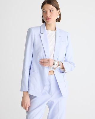 a model wears a light blue blazer with a white T-shirt