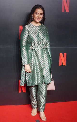 Manisha Koirala wearing a metallic green tunic and trousers on the red carpet