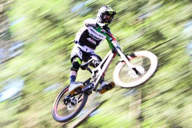 Francesco Colombo of Gravitalia Squadra Corse flys high during the elite men's downhill