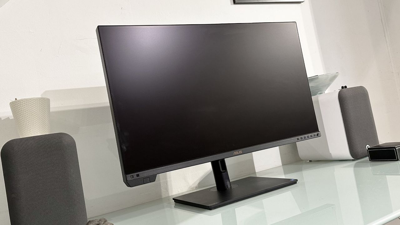 The Asus ProArt PA32KCX 8K monitor on a white desk in a home office during our review process