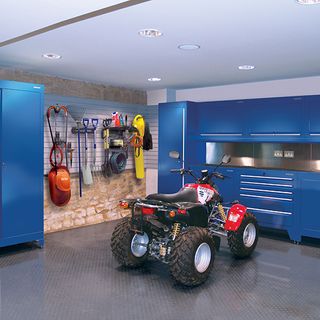 designer garage with quadbike and blue cabinets