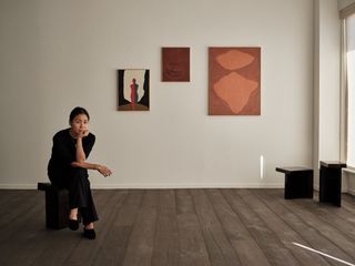 Rosa Park inside Francis Gallery Los Angeles with artworks from the show 'Morning Calm' in the background