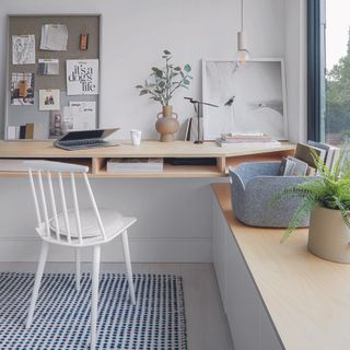 Home office with scandi-inspired desk and a pinboard.