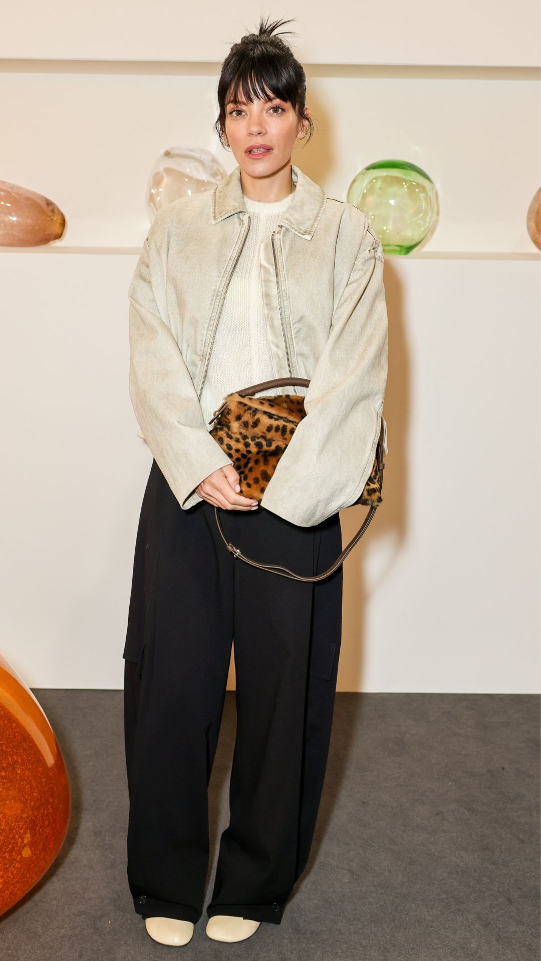 lily allen wearing a bomber jacket and trousers