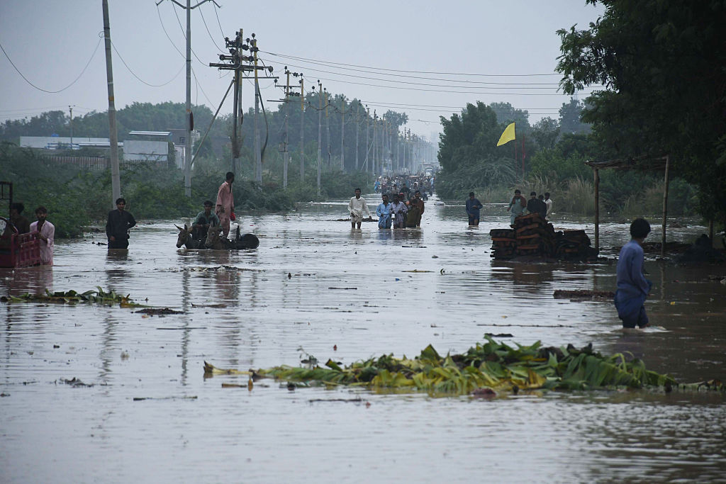 People wade through floodwater after heavy monsoon rains in Karachi, Pakistan.