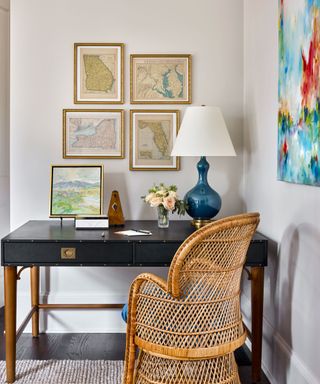 home office desk with gallery wall and rattan chair