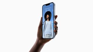 Someone holding an iPhone 14 Plus in Blue