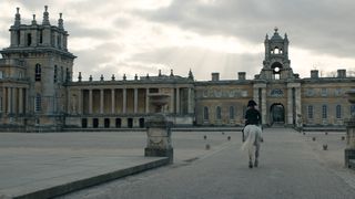 Napoleon VFX; man on horse riding towards large building