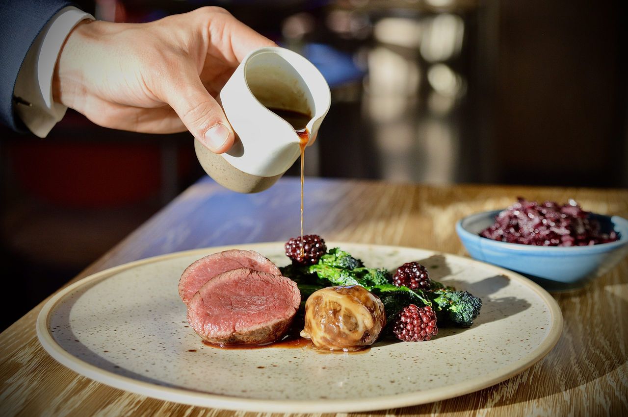 The Clockspire&#039;s roasted venison loin, faggot, slow cooked red cabbage, purple sprouting broccoli and blackberry.