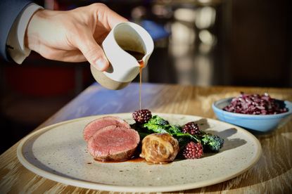 The Clockspire's roasted venison loin, faggot, slow cooked red cabbage, purple sprouting broccoli and blackberry.
