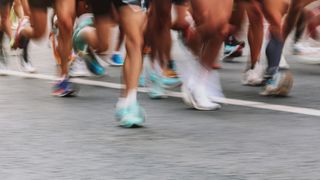 Blur of running shoes on feet of runners