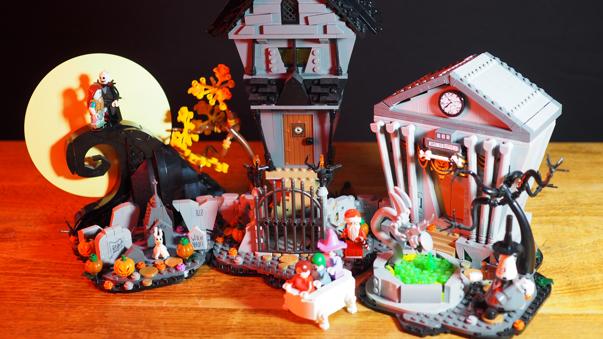 Lego Nightmare Before Christmas sets on a wooden table, against a dark background