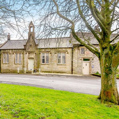 old house with garden view and sage green entrance door
