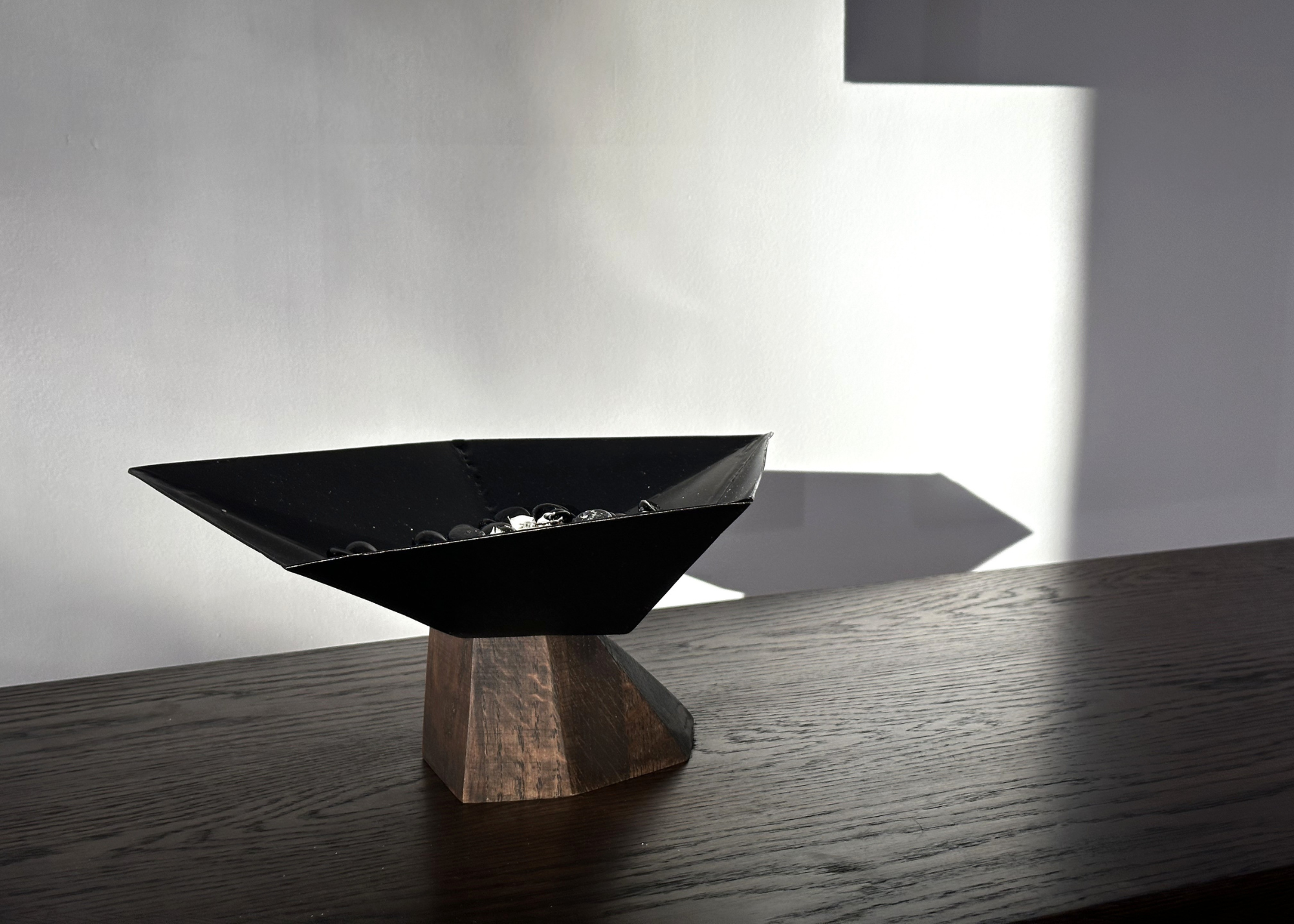 A burner bowl on a dark wood table