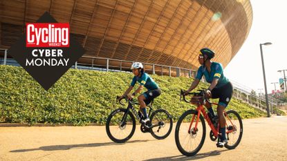 Two women round around Lee Valley Stadium in Rapha clothing 