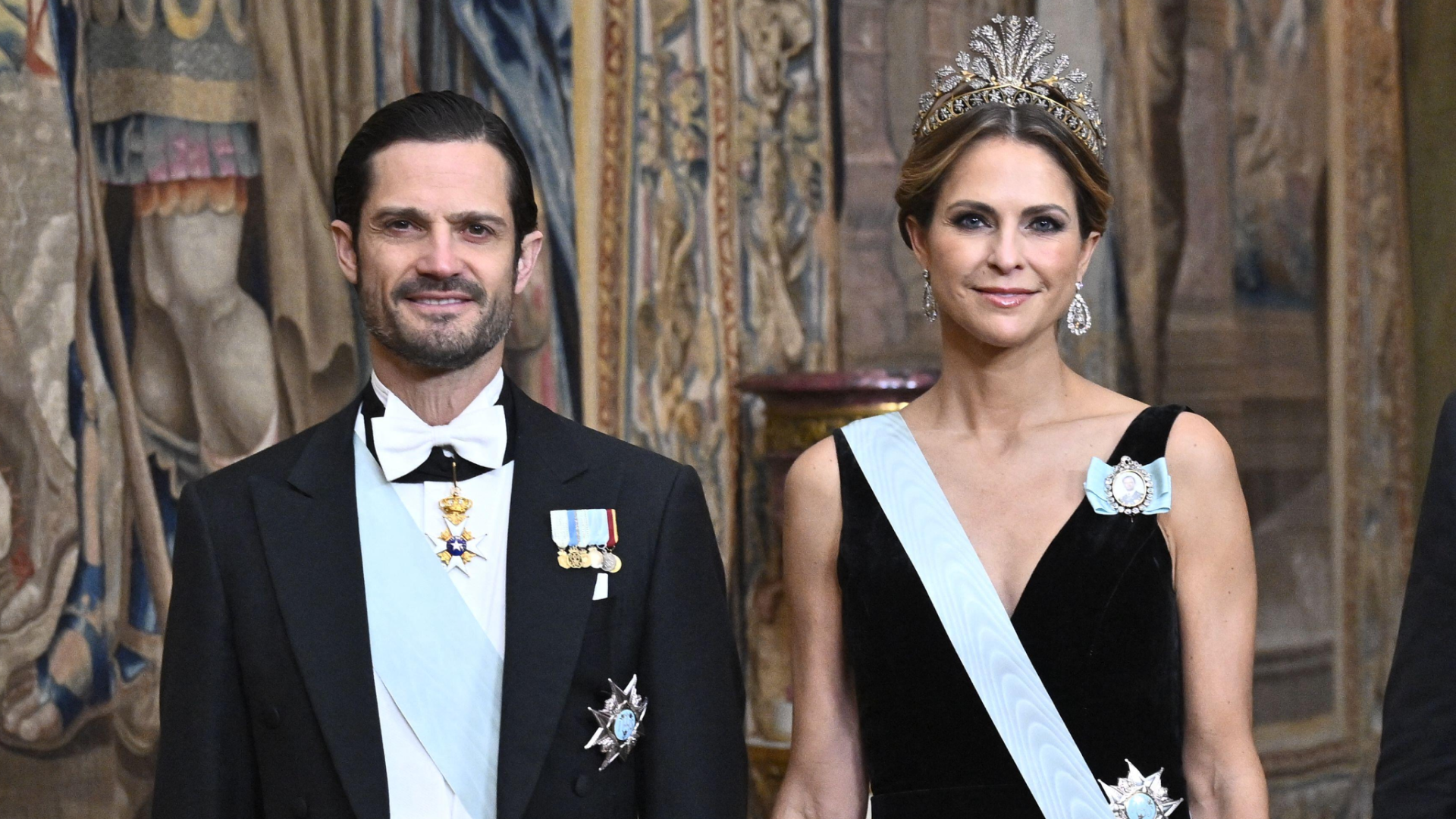 Prince Carl Philip and Princess Madeleine in a suit and black and gown gown at a Nobel dinner