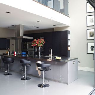 kitchen area with grey kitchen units and chairs