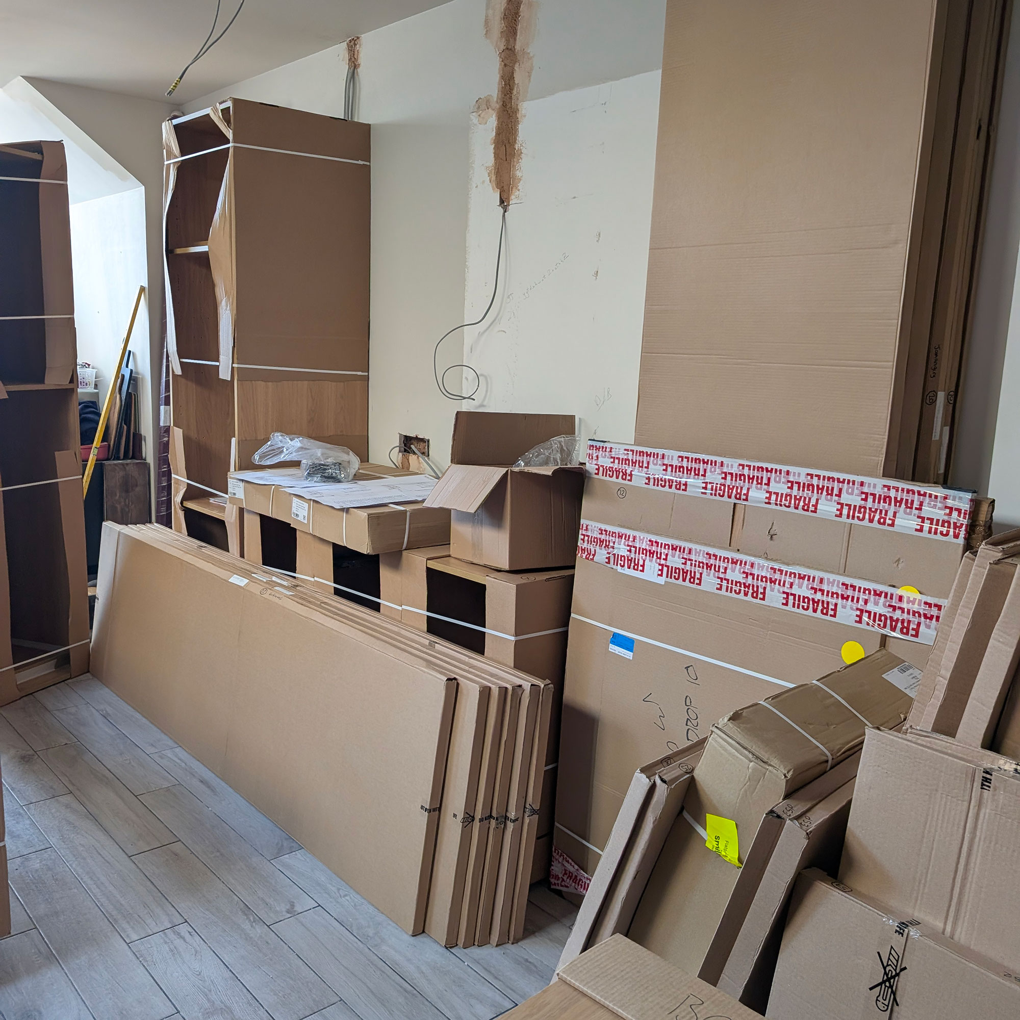 Piles and stacks of cardboard boxes in room