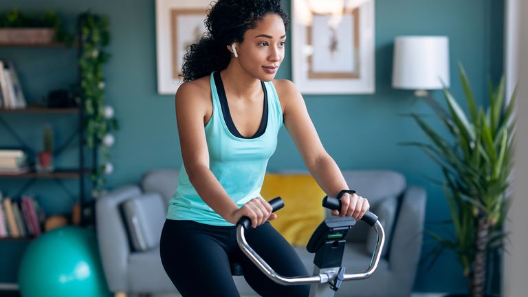 Woman sits on exercise bike