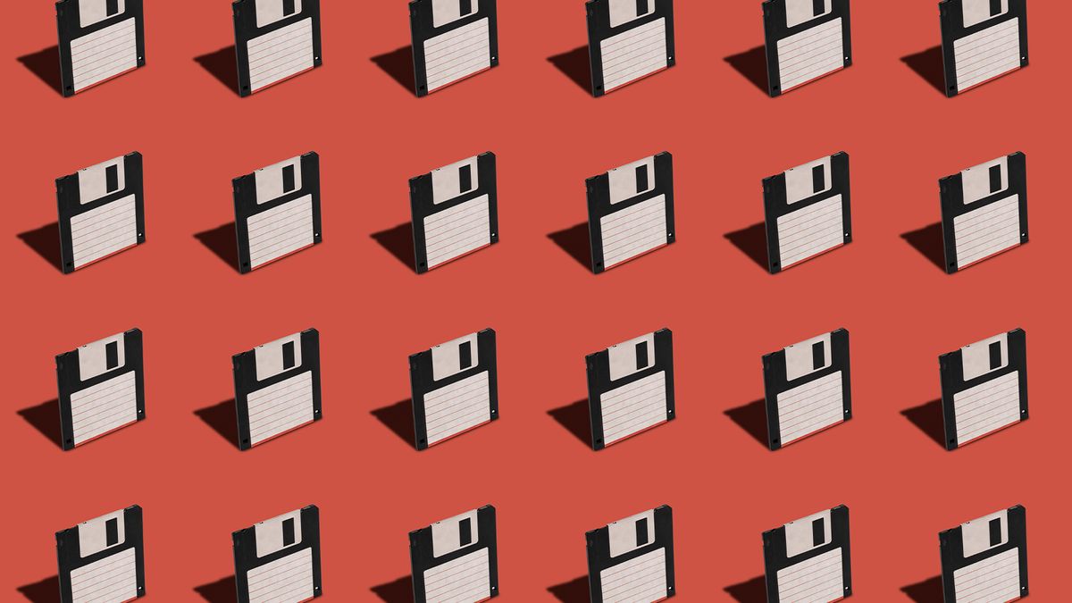 Floppy disks pictured lined up against a red colored backdrop.