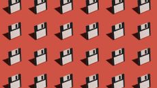 Floppy disks pictured lined up against a red colored backdrop.