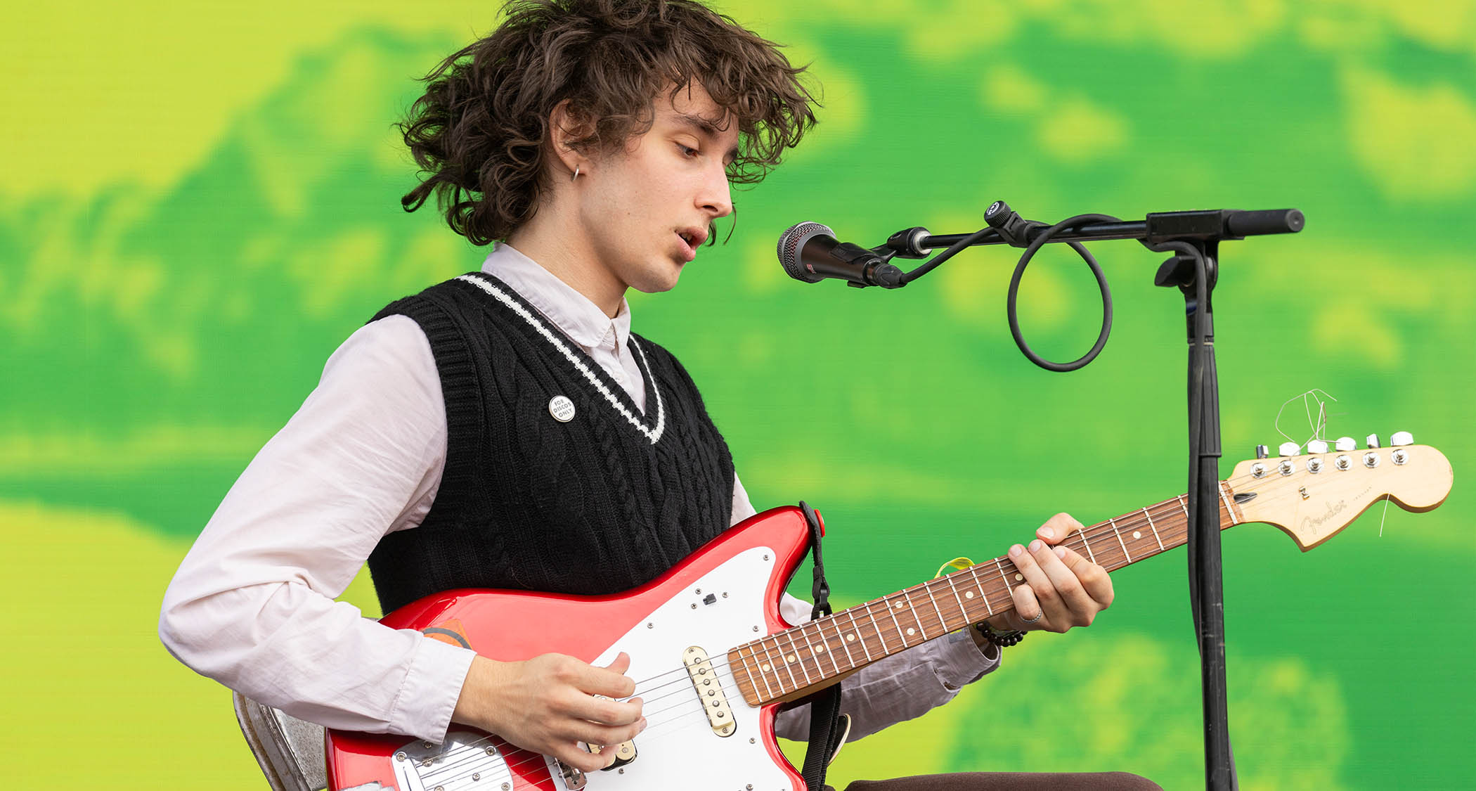 Kai Slater of Lifeguard plays a Fender Jaguar on a stage with a green backdrop.