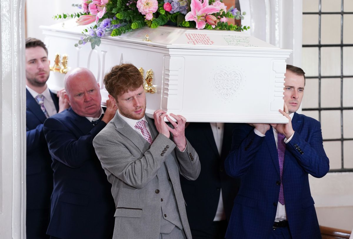 Jay Brown, Ben Mitchell, Phil Mitchell and Callum Highway carrying Lola&#039;s white coffin in EastEnders.