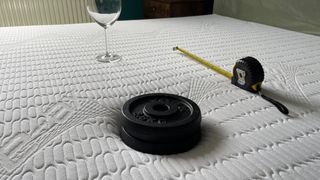REM-Fit Pocket 1000 mattress with weight, tape measure and wine glass resting on it