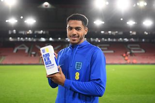 Levi Colwill of England poses for a photograph with their EE Player Of The Match Award after the International Friendly match between England U21 and Germany U21 at Bramall Lane on September 27, 2022 in Sheffield, England.