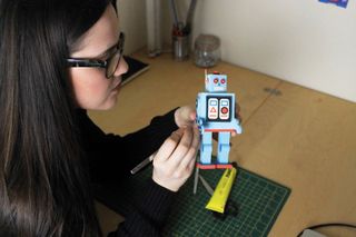 Robot model carefully being glued together