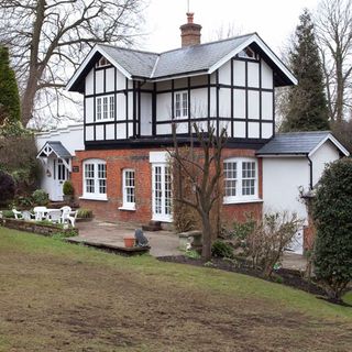 house exterior with white windows and table