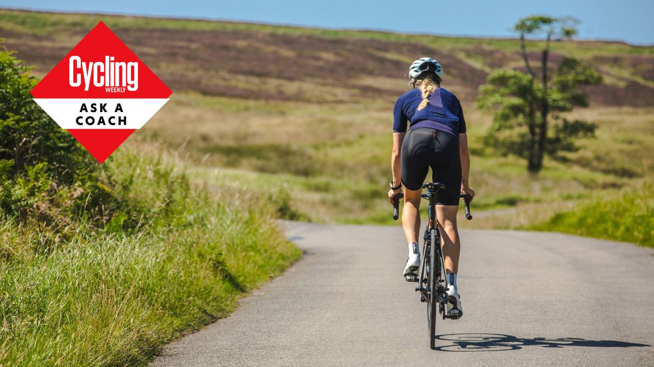 A female cyclist riding towards a hill