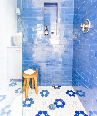 Blue and white hexagonal tile design on shower floor by Mercury Mosaic
