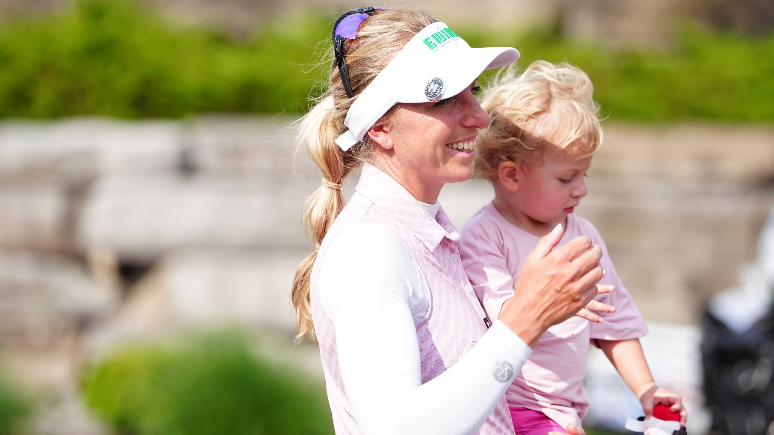 LPGA golfer Sophia Popov holds her daughter Maya Mehles at the 2025 Dow Championship