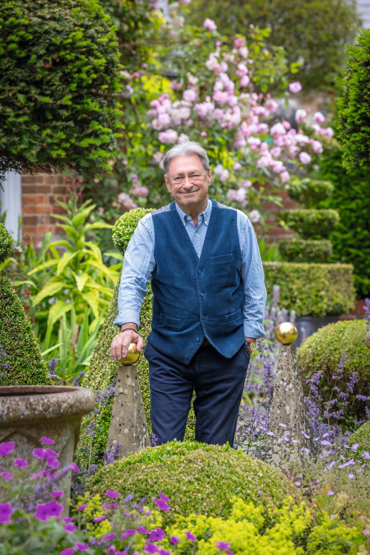 Alan Titchmarsh in the garden at his home in Hampshire. This is the border by the terrace, where he grows repeating mounds of nepeta, Alchemilla mollis and Geranium ‘Patricia’. He does most of the work himself, even shinning up ladders to prune the roses.