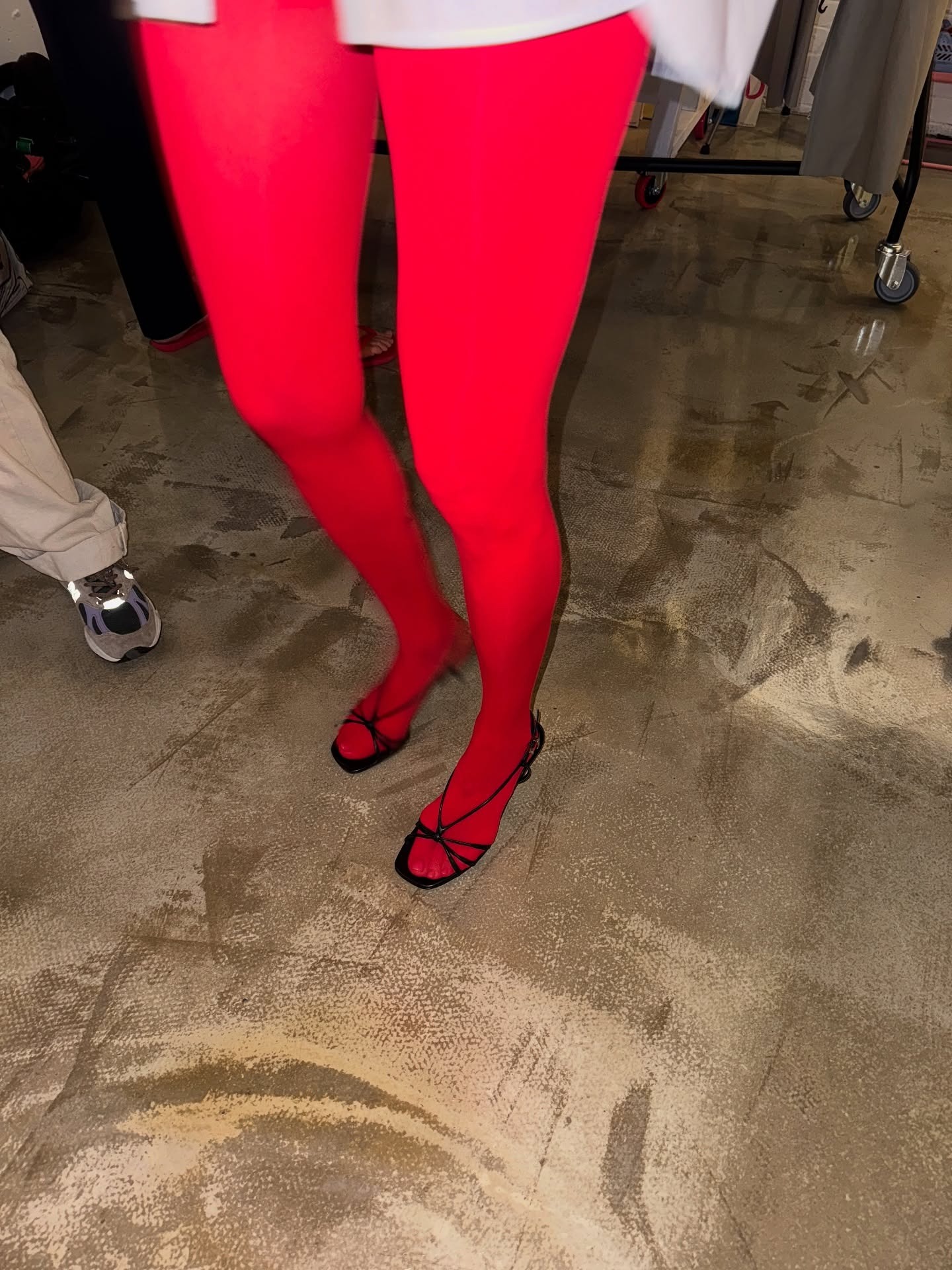 Fashion person Alexis Foreman wears a coloured tight outfit. She wears bright red tights.