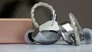 Hidizs MS145 earbuds on gray background