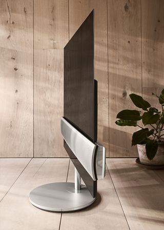 wooden flooring and wooden wall with music system on tv screen