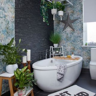bathroom with star on wall and bathtub near potted plant