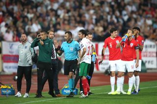Referee Ivan Bebek (centre) twice stopped England's match in Bulgaria