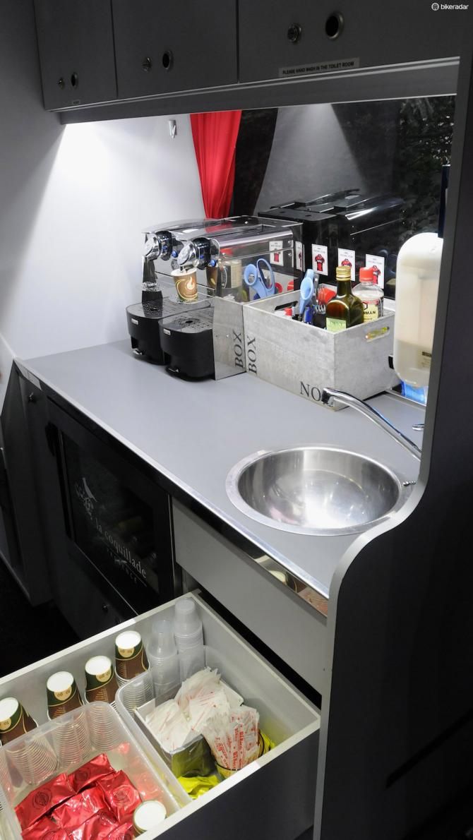 First stop of course is the twin coffee machines in the compact kitchen area. Behind the drawer is a wine fridge, filled with team owner Andy Rihs' finest own produce