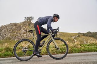 Image shows a rider wearing overshoes to avoid cold feet while cycling.