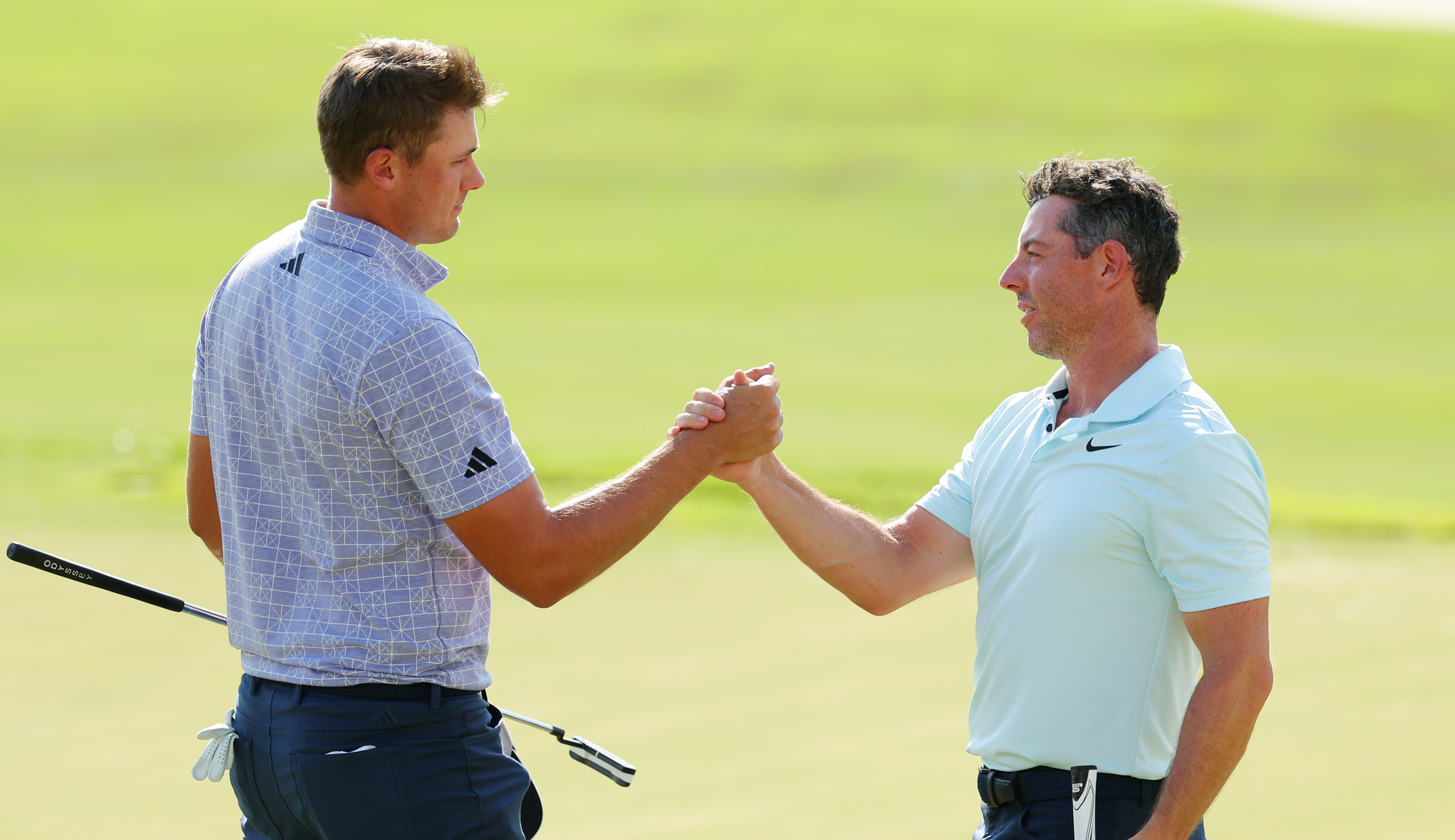 Ludvig Aberg and Rory McIlroy shake hands on the 18th green
