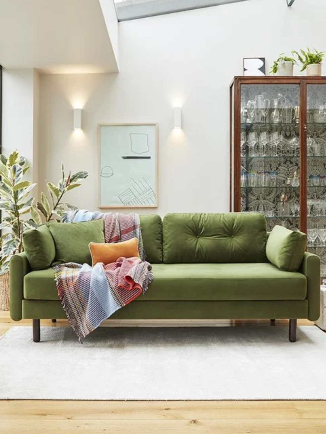 A green three-seater sofa bed from Swyft