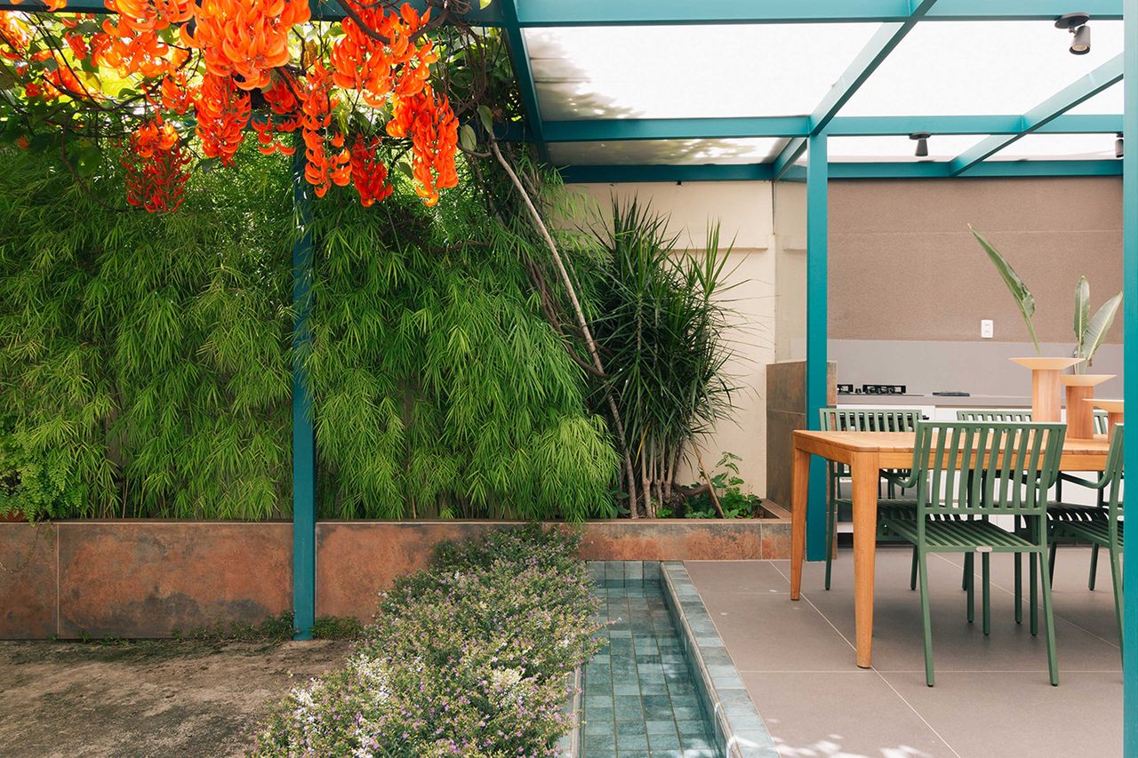 a colorful backyard with a blue pergola