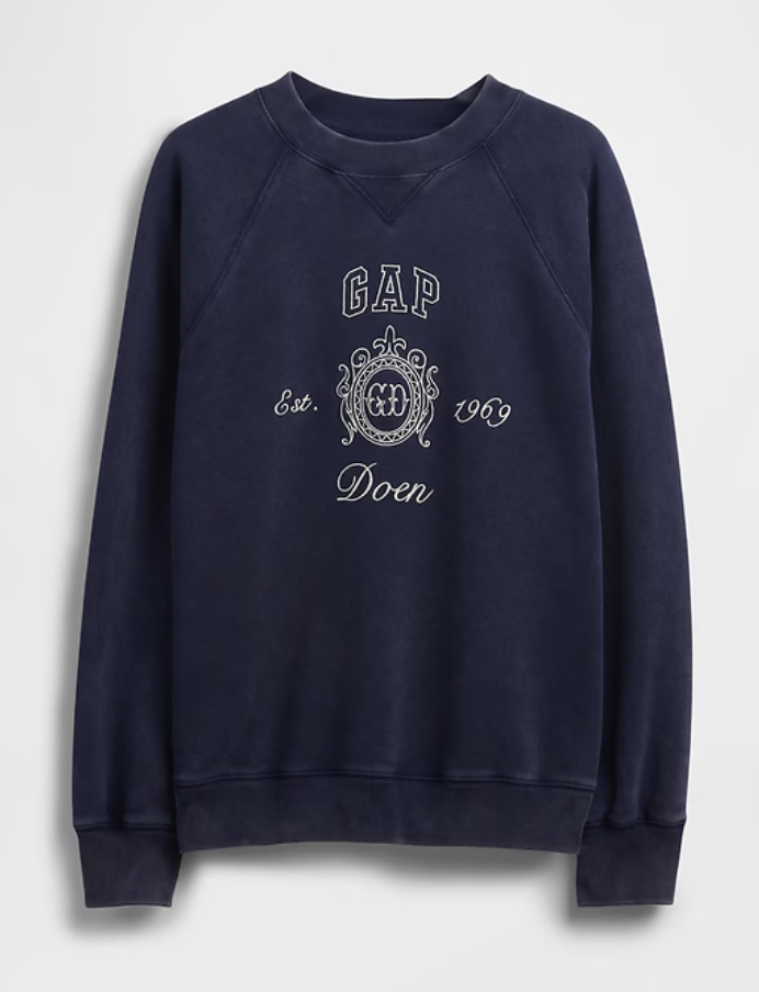 a gap sweatshirt in front of a plain backdrop