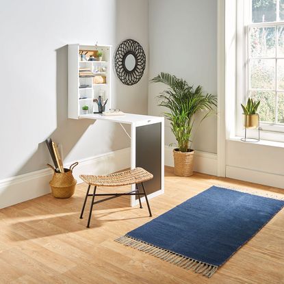 white wall with white compact living desk and shelve